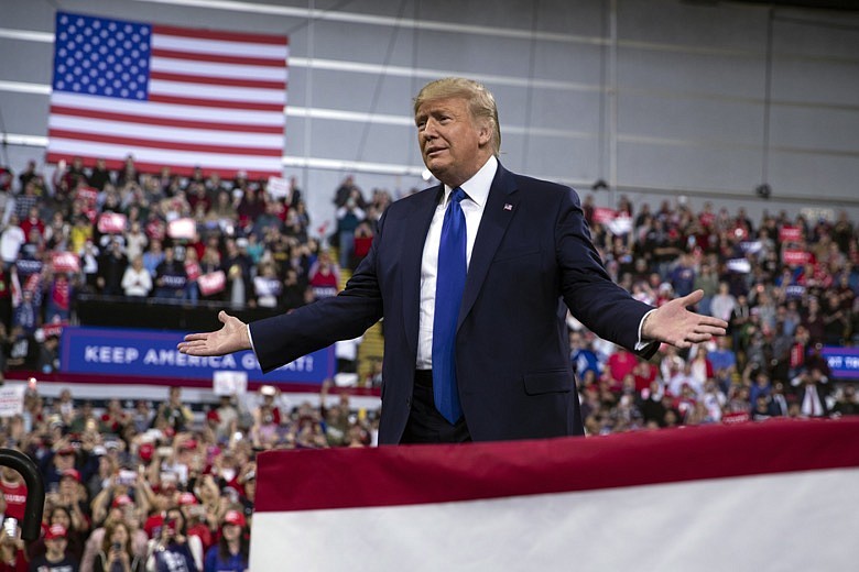 In this Jan. 14, 2020, photo, President Donald Trump arrives at UW-Milwaukee Panther Arena to speak at a campaign rally in Milwaukee. Trump's surrogates are fanning out across the country as part of an aggressive effort to stretch his appeal beyond the base of working-class white voters who propelled him to victory in 2016 (AP Photo/ Evan Vucci)