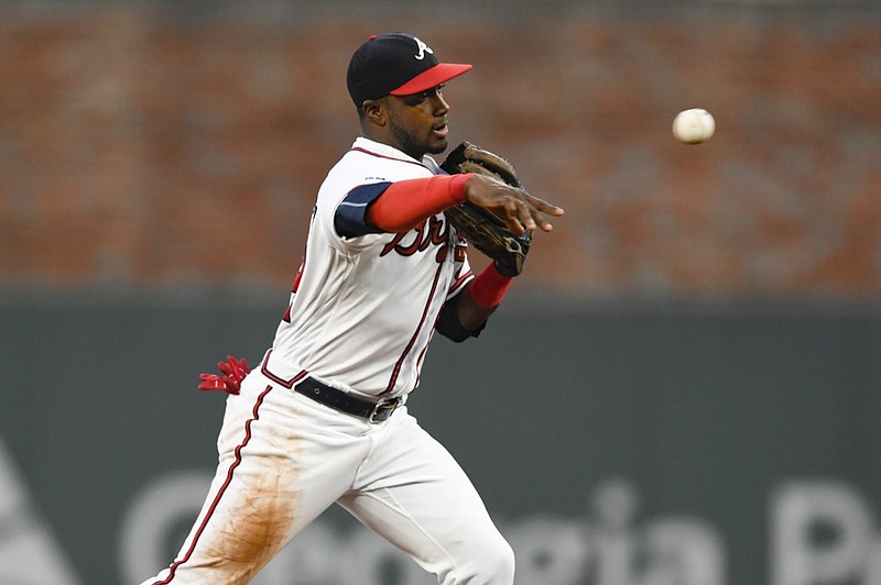 Atlanta Braves second baseman Adeiny Hechavarria throws out the San Francisco Giants' Evan Longoria at first base after forcing out Buster Posey at second for a double play during the first inning on Sept. 21 in Atlanta. / AP photo by John Amis


