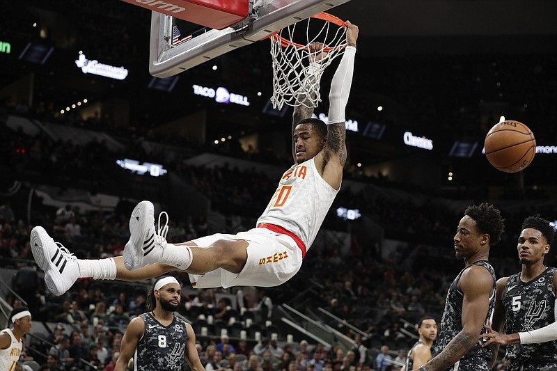 Atlanta Hawks forward John Collins dunks during Friday night's road win against the San Antonio Spurs. / AP photo by Eric Gay