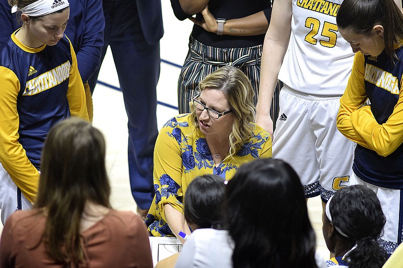 UTC women's basketball coach Katie Burrows talks to her players during a timeout at a home game against Furman on Jan. 18. / Staff photo by Robin Rudd