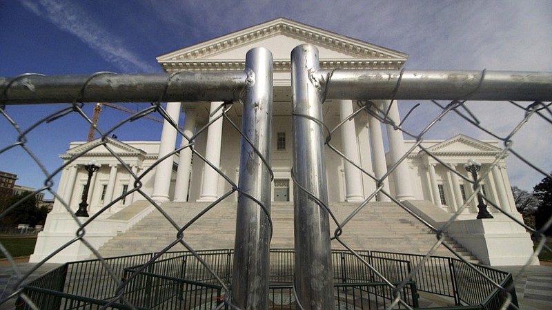 The Virginia state Capitol building is surrounded by fencing, Thursday, Jan. 16, 2020 in Richmond, Va., in preparation for Monday's rally by gun rights advocates. (Dean Hoffmeyer/Richmond Times-Dispatch via AP)


