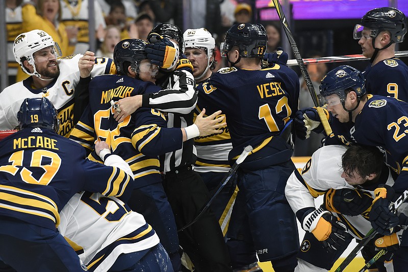 The Nashville Predators, in white, and the Buffalo Sabres fight during the second period of Saturday night's game in Nashville. The Predators won the game 2-1. / AP photo by Mark Zaleski