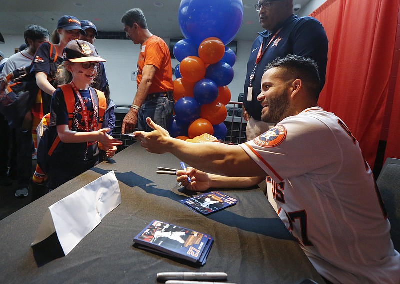 Houston Astros second baseman Jose Altuve signs autographs for young fans during the team's fan event Saturday at Minute Maid Park in Houston. / AP photo by Steve Gonzales