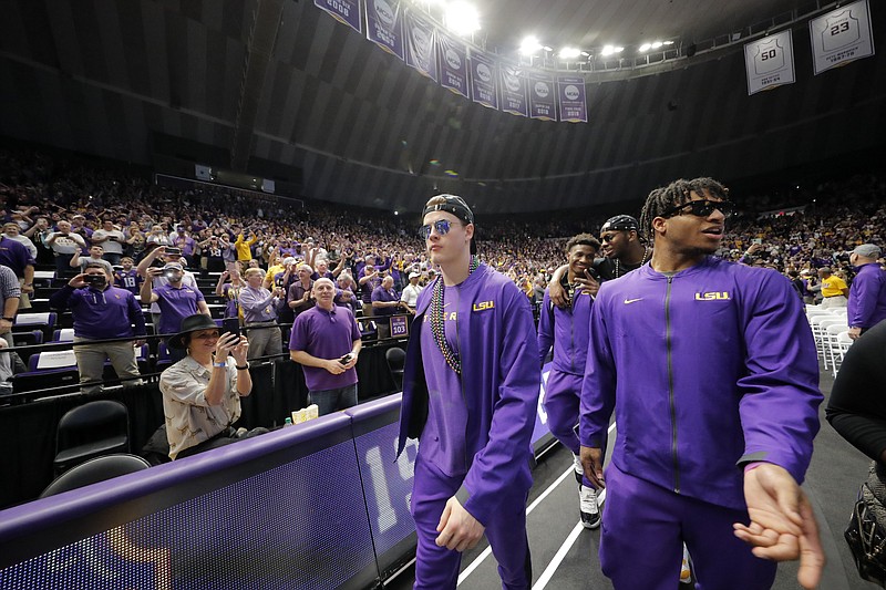 LSU quarterback Joe Burrow, left, and wide receiver Ja'Marr Chase walk into the Pete Maravich Assembly Center during a celebration of their national championship on Saturday in Baton Rouge, La. / AP photo by Gerald Herbert