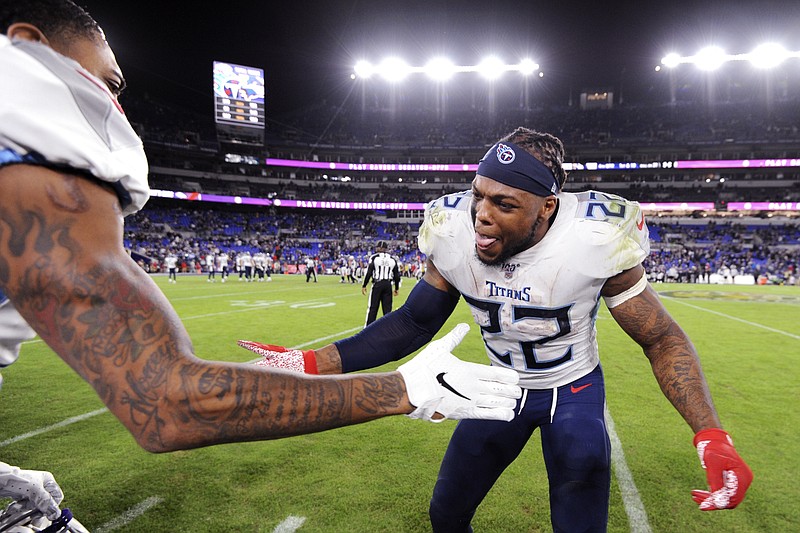 Tennessee Titans running back Derrick Henry, right, celebrates during the second half of his team's NFL divisional playoff victory against the Baltimore Ravens on Jan. 11. The Titans won 28-12. / AP photo by Gail Burton