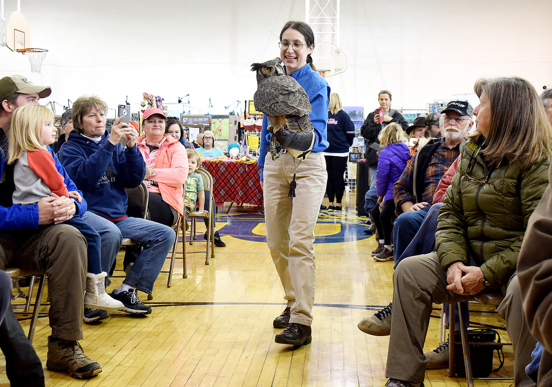 Staff Photo by Robin Rudd/ Beth Parker, of the American Eagle Foundation, brings a female great horned owl down the center aisle of the Birchwood Community Center. The 29th Annual Tennessee Sandhill Crane Festival celebrates the thousands of birds that migrate through or spend the winter on and around the Hiwassee Refuge. The festival, the final day was January 19, 2020, also provides an opportunity to focus on the rich wildlife heritage of the state and the Native American history of the area.