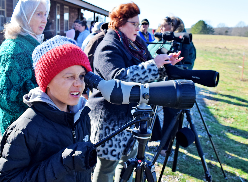 Staff Photo by Robin Rudd/ Cais Lam uses a spotting scope provided by the Tennessee Ornithological Society to view the cranes at the Hiwassee Refuge. The 29th Annual Tennessee Sandhill Crane Festival celebrates the thousands of birds that migrate through or spend the winter on and around the Hiwassee Refuge. The festival, the final day was January 19, 2020, also provides an opportunity to focus on the rich wildlife heritage of the state and the Native American history of the area.