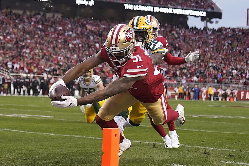 San Francisco 49ers running back Raheem Mostert scores in front of Green Bay Packers free safety Darnell Savage during the first half of the NFC title game Sunday in Santa Clara, Calif. / AP photo by Tony Avelar