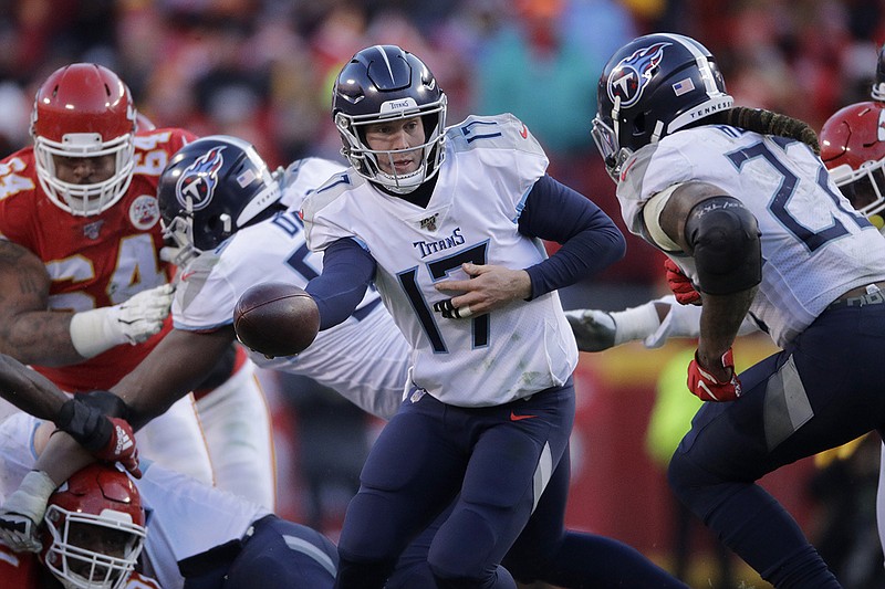 Tennessee Titans quarterback Ryan Tannehill hands off to Derrick Henry during the second half of the AFC title game on Sunday in Kansas City, Mo. The host Chiefs won 35-24 to avenge a regular-season loss from November in Nashville and advance to the Super Bowl. Henry and Tannehill, both crucial to the team's midseason turnaround and playoff run, will soon be free agents. / AP photo by Charlie Riedel