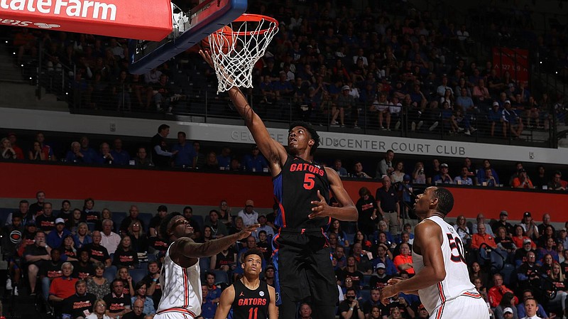 Florida photo/Alex de la Osa / Auburn's Danjel Purifoy (3) and Austin Wiley (50) watch as Florida's Omar Payne goes up for two of his 19 points during this past Saturday's 69-47 drubbing of the Tigers by the Gators.