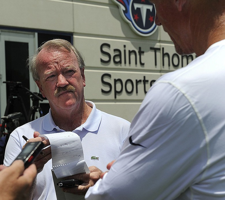 Columnist David Climer talks with Titans coach Ken Whisenhunt after a practice in this file photo. Climer, whose award-winning career at The Tennessean spanned more than 40 years, died Sunday, Jan. 19, 2020, in Nashville after a battle with cancer. (Photo: George Walker IV / The Tennessean)