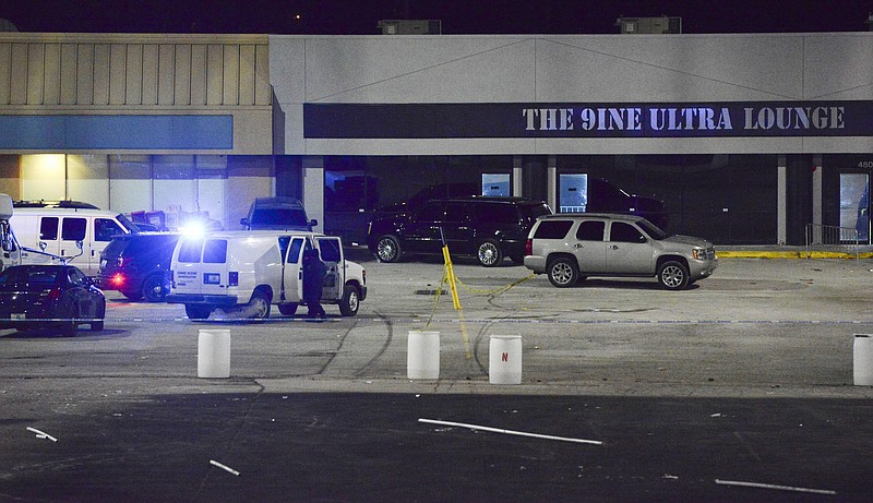 Kansas City, Mo., police crime scene investigators gather evidence at the scene of a shooting at a nightclub in the early hours of Monday, Jan. 20, 2020, in Kansas City, Mo. Police say an armed security guard may have shot and killed a man suspected of fatally shooting a woman and injuring 15 more people outside a bar in Kansas City(Luke Nozicka/The Kansas City Star via AP)