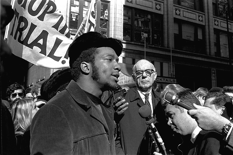 In this Oct. 29, 1969, file photo, Fred Hampton, center, chairman of the Illinois Black Panther party, speaks outside a rally outside the U.S. Courthouse in Chicago while Dr. Benjamin Spock, background, listens. "The First Rainbow Coalition," a new PBS documentary, is exploring a little-known movement in 1960s Chicago that brought together blacks, Latinos, and poor whites from Appalachia that later resulted in the upending of politics in the American Midwest. (AP Photo/ESK, File)