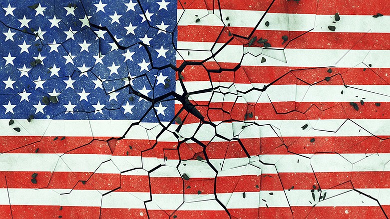 US flag on cracked concrete.  / Getty Images/iStockphoto/Paul Campbell