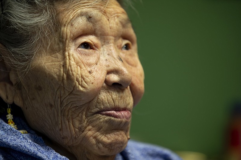 In this Monday, Jan. 20, 2020 image, Lizzie Chimiugak looks on at her home in Toksook Bay, Alaska. Chimiugak, who turned 90 years old on Monday, is scheduled to be the first person counted in the 2020 U.S. Census on Tuesday. (AP Photo/Gregory Bull)