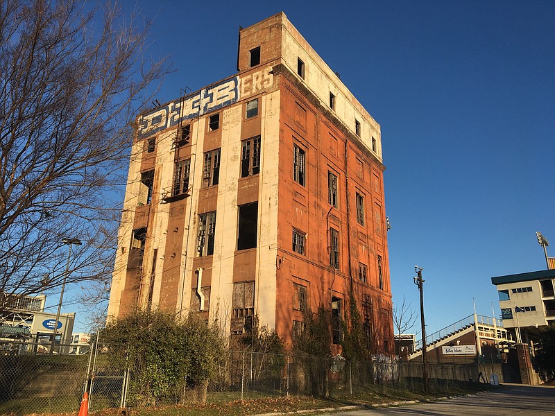 The Parkway Towers building, standing empty with broken windows and covered with graffiti, is up for sale for $2.65 million. The 5-story builidng is near a new luxury apartment complex taking shape and next to the First Horizon Pavilion and Finley Stadium at 1823 Reggie White Boulevard. / Photo by Dave Flessner