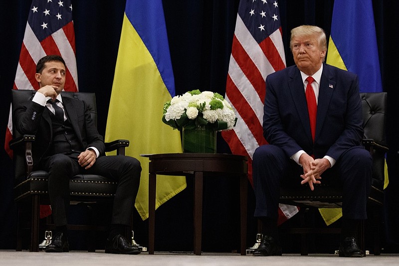 FILE - In this Sept. 25, 2019, file photo, President Donald Trump meets with Ukrainian President Volodymyr Zelenskiy at the InterContinental Barclay New York hotel during the United Nations General Assembly, in New York. It's the story of a president who either had a "perfect phone call" with Ukraine or abused his power and should be removed from office. What to watch as presidential impeachment arguments get underway in the Senate for only the third time in American history. (AP Photo/Evan Vucci, File)