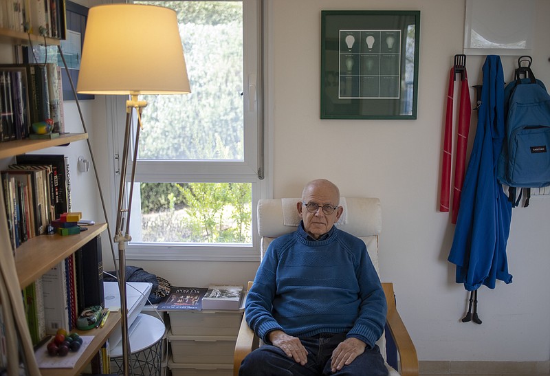 In this Friday, Jan. 17, 2020, photo, Holocaust survivor Maurice Gluck, poses for a photo in his home in Ya'ad, northern Israel. Shortly before they were rounded up by Nazi troops in Belgium and deported to Auschwitz in 1942, the parents of three-year-old Maurice Gluck placed their only child in the care of a local Christian family. Gluck forgot his Yiddish mother tongue and that he even had parents of his own. (AP Photo/Ariel Schalit)