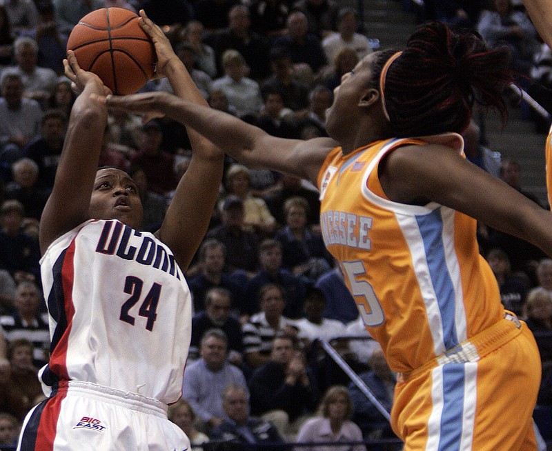 Tennessee's Nicky Anosike, right, defends as Connecticut's Charde Houston shoots during the first half on Jan. 6, 2007, in Hartford, Conn. The iconic women's basketball programs with a combined 19 NCAA championships will face off Thursday night in Hartford in the first series meeting since that game. / AP photo by Bob Child