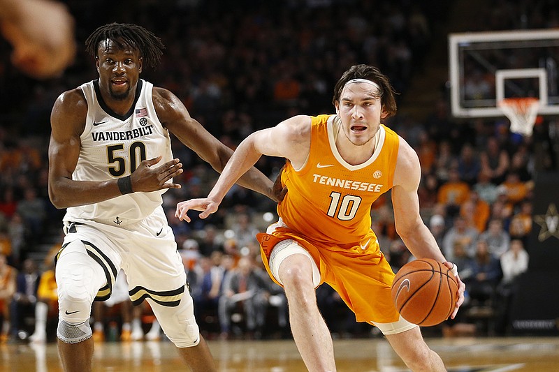 Tennessee forward John Fulkerson dribbles past Vanderbilt counterpart Ejike Obinna during the first half of Saturday night's game in Nashville. Fulkerson has averaged 12.8 points and eight rebounds the past four games. / AP photo by Mark Humphrey