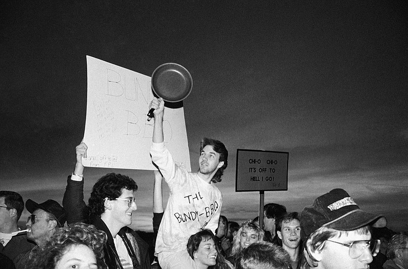 Demonstrators rejoice as Theodore Bundy is executed in Florida's electric chair, Tuesday, Jan. 24, 1989, Starke, Fla. (AP Photo/Mark Foley)