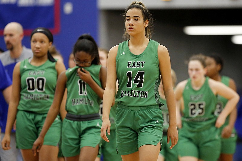 Madison Hayes (14) and her East Hamilton teammates walk off the court after a double-overtime loss to host Cleveland on Jan. 10. / Staff photo by C.B. Schmelter