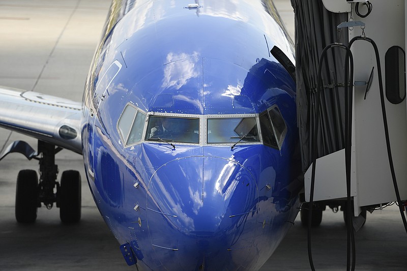 FILE - In this Sept. 9, 2019, file photo Southwest pilots prepare for a flight at Tampa International Airport in Tampa, Fla. Southwest Airlines Co. reports financial results Thursday, Jan. 23, 2020. (AP Photo/Mike Stewart, File)