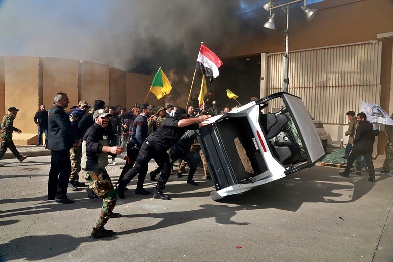 In this Dec 31, 2019, file photo, protesters damage property inside the U.S. embassy compound, in Baghdad, Iraq. Iran has had its fingers in Iraq's politics for years, but the U.S. killing of an Iranian general and Iraqi militia commander outside Baghdad has added new impetus to the effort, stoking anti-Americanism that Tehran now hopes it can exploit to help realize the goal of getting U.S. troops out of the country. (AP Photo/Khalid Mohammed, File)