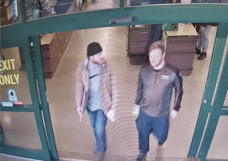 This image from a Jan. 1, 2020 surveillance video and released in a U.S. Attorney detention memorandum, shows Brian Mark Lemley Jr, right, and Patrik Mathews leaving a store in Delaware where they purchased ammunition and paper shooting targets. The pair, along with William Garfield Bilbrough IV, plotted to carry out "essentially a paramilitary strike" at a Virginia gun rights rally, a federal prosecutor said Wednesday, Jan. 22, 2020. FBI agents arrested Mathews, Lemley and Bilbrough on Jan., 16, 2020, as part of a broader investigation of The Base, a white supremacist group. (U.S. Attorney via AP)


