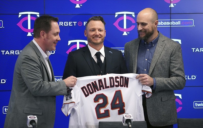 New Minnesota Twins third baseman Josh Donaldson, flanked by team executive Derek Falvey, left, and team manager Rocco Baldelli, is introduced during a news conference Wednesday at Target Field in Minneapolis. / AP photo by Brian Peterson
