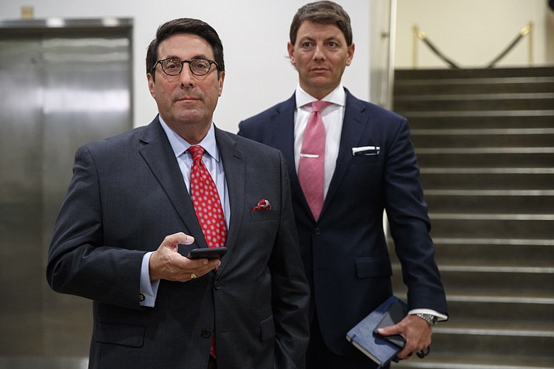 President Donald Trump's personal attorney Jay Sekulow, left, accompanied by Deputy White House press secretary Hogan Gidley, waits his turn to speak to the media during a break in the impeachment trial of President Donald Trump on charges of abuse of power and obstruction of Congress, Thursday, Jan. 23, 2020, on Capitol Hill in Washington. (AP Photo/ Jacquelyn Martin)