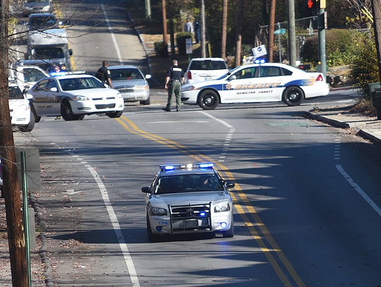 A Collegedale police officer drives down North Chamberlain Avenue Dec. 1, 2016 after an officer was shot three times by an unknown assailant while checking an abandoned building near the intersection of Glenwood Avenue and Mission Avenue. The officer was treated at Erlanger Hospital and was released. / Staff file photo