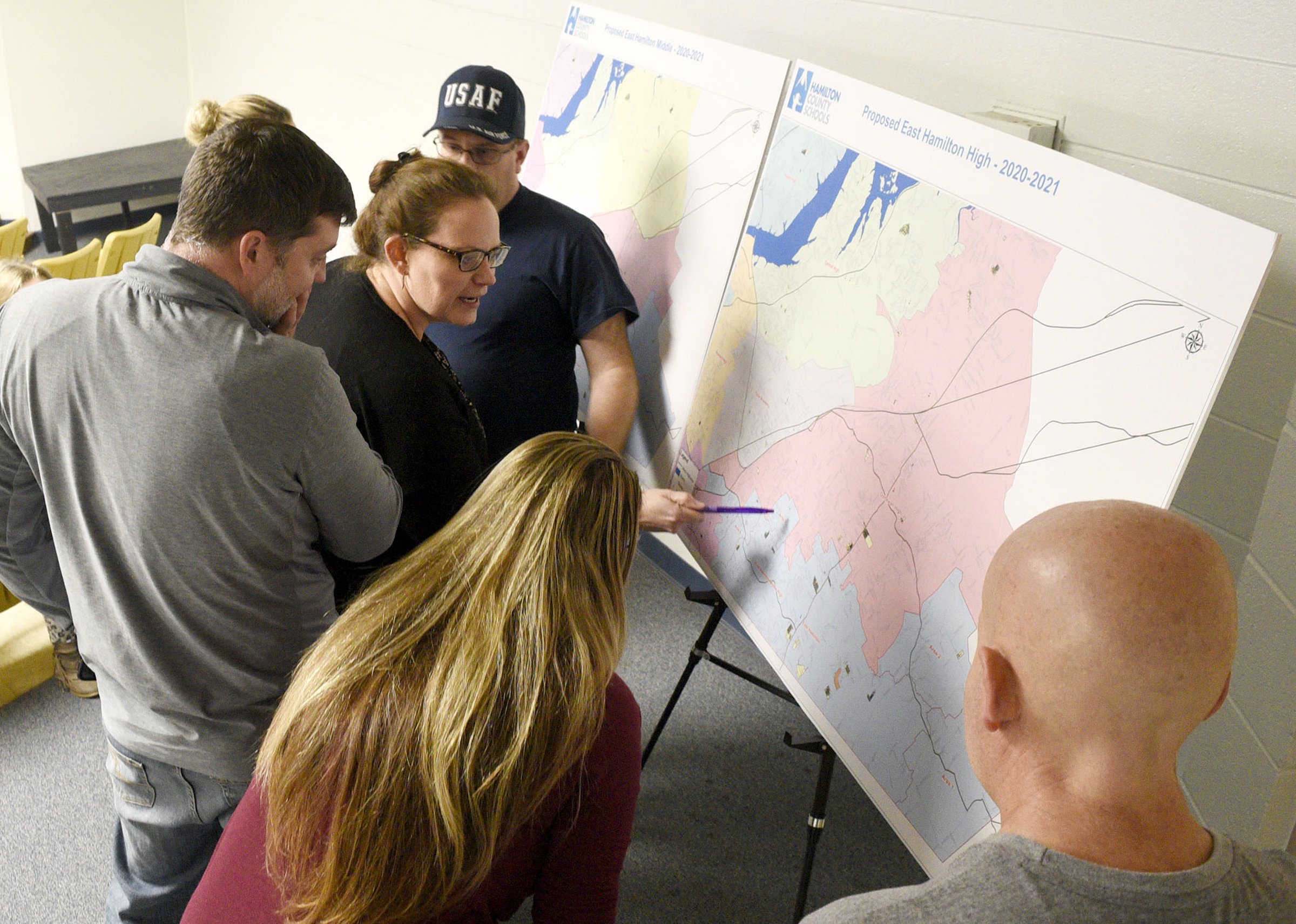 Staff Photo by Robin Rudd/ Arielle Stephens, center, points to a area of concern while other people look at the maps detailing the proposed re-zoning. The conversation about rezoning some of Hamilton County Schoolsՠattendance zones began with a meeting to discuss the East Hamilton/Ooltewah rezoning at Ooltewah Middle School Tuesday night. This is the first of three such meetings.