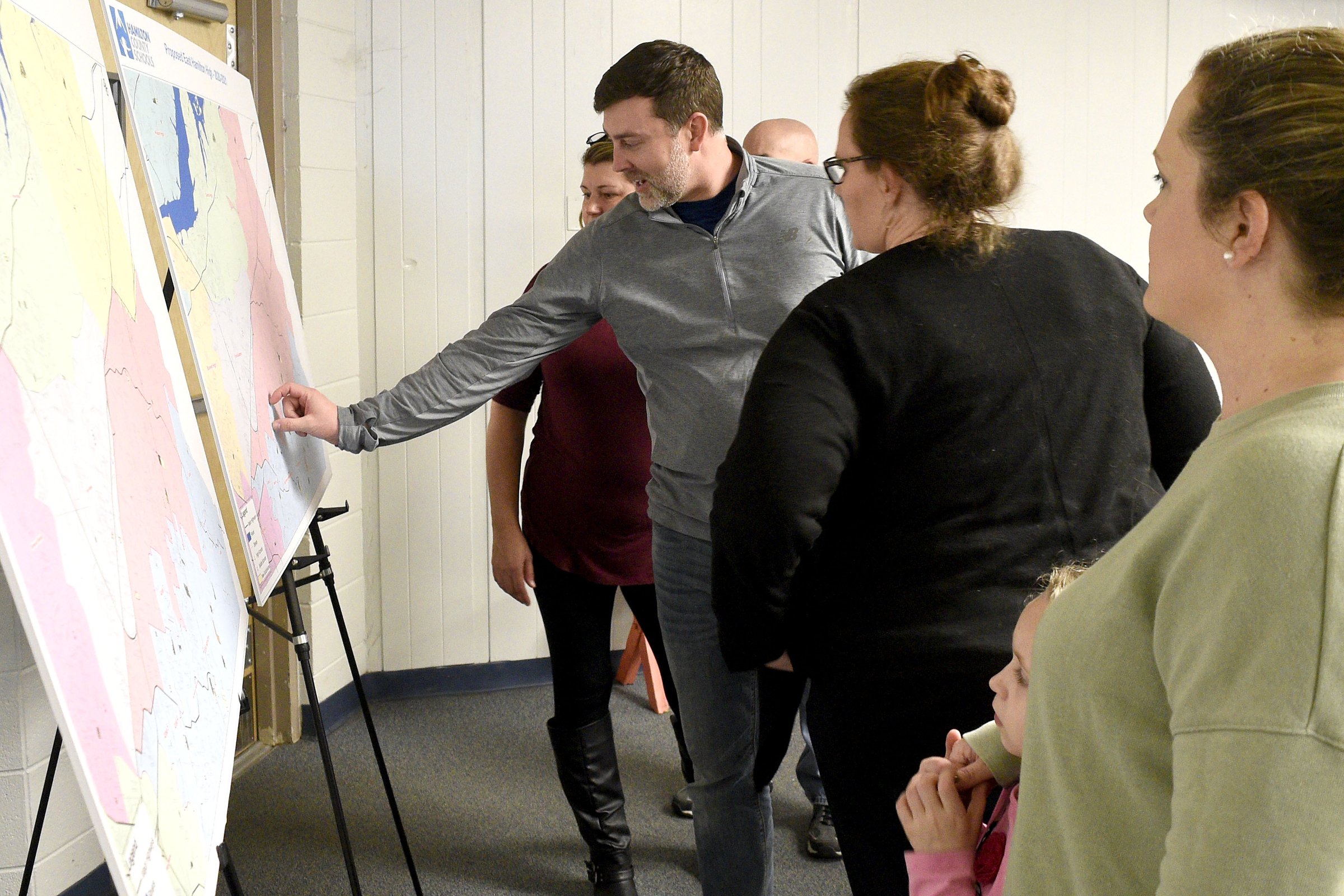 Staff Photo by Robin Rudd/ Graysen Ballard, center, points to a area of concern while other people look at the maps detailing the proposed re-zoning. The conversation about rezoning some of Hamilton County Schoolsՠattendance zones began with a meeting to discuss the East Hamilton/Ooltewah rezoning at Ooltewah Middle School Tuesday night. This is the first of three such meetings.