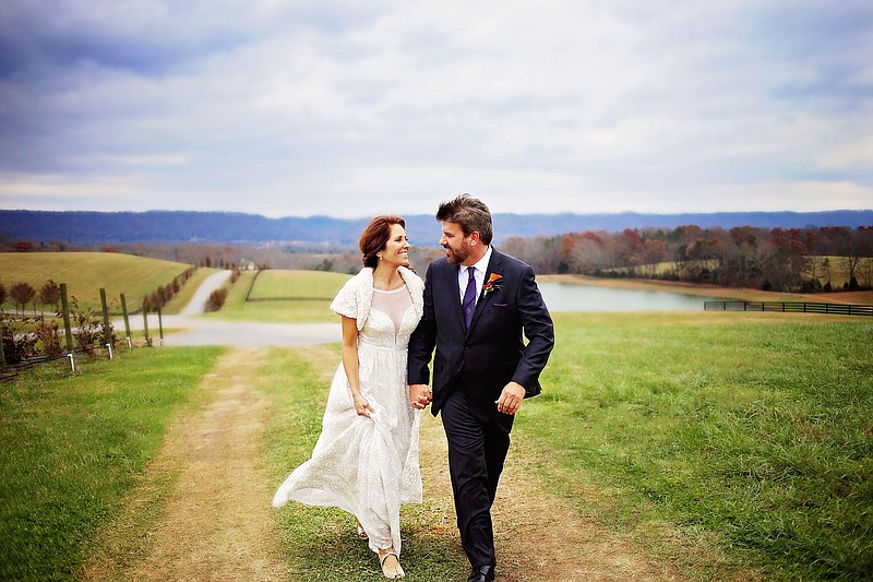 Contributed photo by Jennette Brito/Jennette Leigh Photography / Talene and Don Howe walk the Howe Farms property during their wedding, for which they transformed Don Howe's former hobby farm into a wedding venue. They opened the venue to the public in 2015, and they've since added a second venue and are currently expanding with plans to add four more this year.