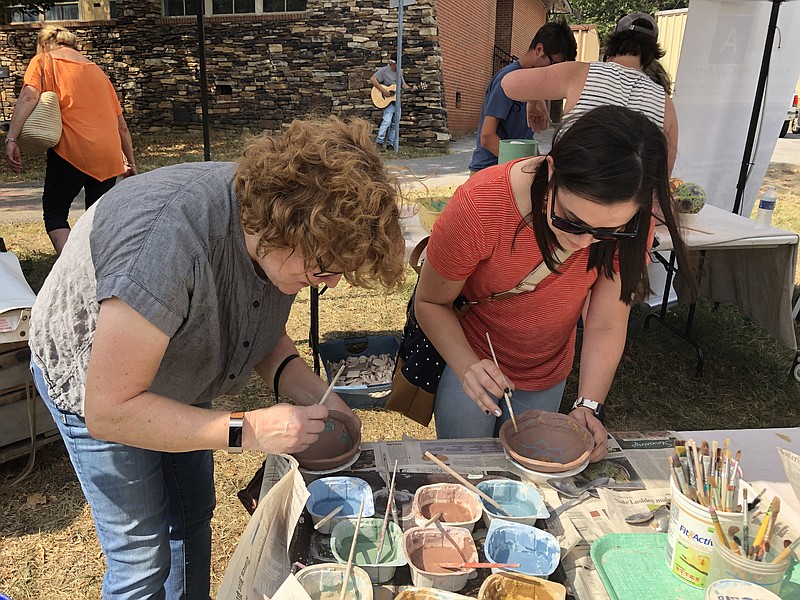 Community members paint bowls to be sold in the Empty Bowls Sale hosted by Scenic City Clay Arts to benefit Family Promise. / Contributed photo by Joy Key