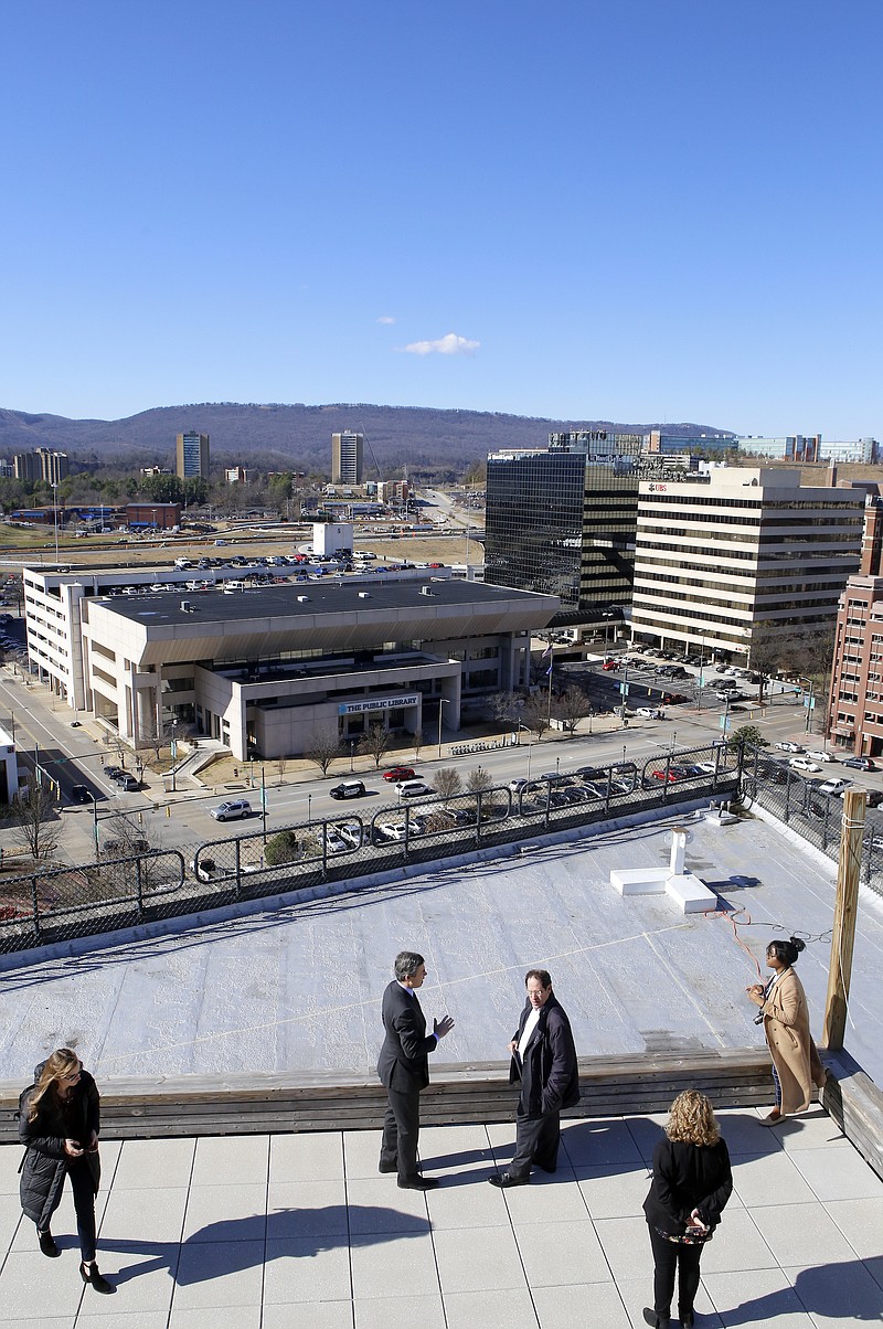 Staff file photo by C.B. Schmelter / Mayor Andy Berke, center left, and Brookings Institute scholar and author Bruce Katz look out over Chattanooga from the roof of the Edney Innovation Center while touring the downtown Innovation District in 2018.