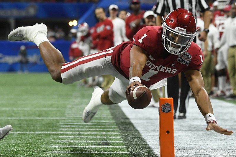 AP photo by John Amis / Oklahoma quarterback Jalen Hurts scores a touchdown against LSU during the second half of the Peach Bowl national semifinal on Dec. 28 in Atlanta.