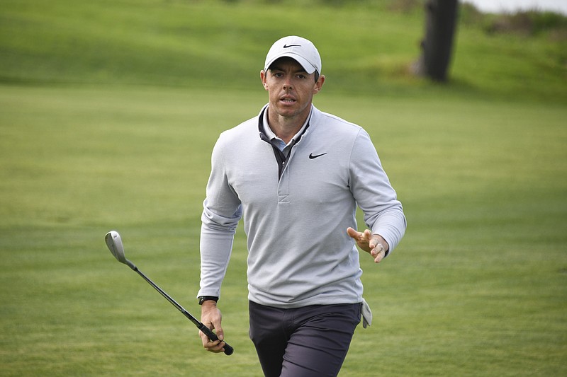 Rory McIlroy waves to the gallery after hitting out of a fairway bunker on the fourth hole of the South Course at Torrey Pines during the second round of the Farmers Insurance Open on Friday in San Diego. / AP photo by Denis Poroy