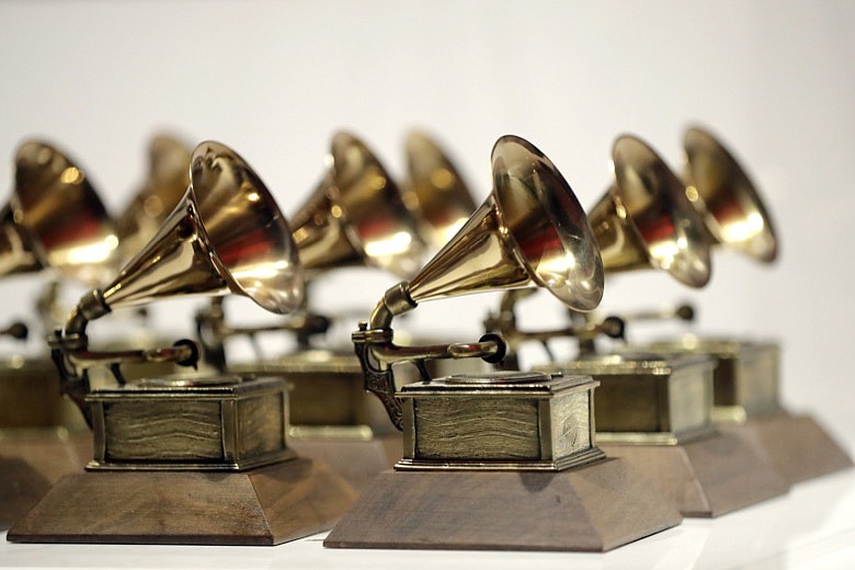 In this Oct. 10, 2017, file photo, various Grammy Awards are displayed at the Grammy Museum Experience at Prudential Center in Newark, N.J. The academy, which puts on the 62nd Grammys on Sunday, Jan. 26, 2020, says nominees are selected from a list of contenders who are voted into the top 20 in each category. But some people view the voting process as less than transparent, since the choice of finalists happens behind closed doors. (AP Photo/Julio Cortez, File)