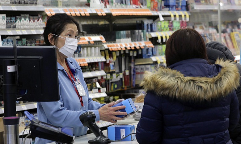 A sales clerk at a pharmacy rings up a purchase of face masks as fears of the coronavirus continues, Friday, Jan 24, 2020 in Chicago. A Chicago woman has become the second U.S. patient diagnosed with the dangerous new virus from China, health officials announced Friday. (Antonio Perez/Chicago Tribune via AP)