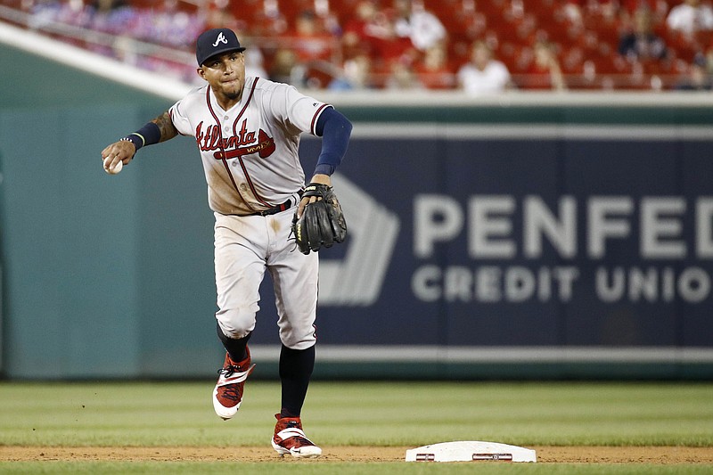 Johan Camargo throws out the Washington Nationals' Howie Kendrick at first base while playing shortstop for the Atlanta Braves on July 30, 2019. Camargo filled a utility role for the Braves last season and struggled at the plate, but now he will have a chance to compete for the starting spot at third base again. / AP photo by Patrick Semansky