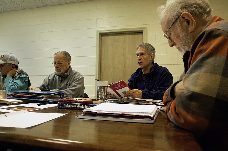 Staff photo by Wyatt Massey / Jim Henry, right, listens as Robert Smith, second from right, reads the opening meditation for the weekly intensive journaling practice at First Christian Church on Jan 23.