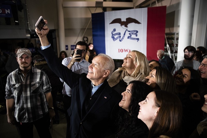 Democratic presidential candidate former Vice President Joe Biden makes a selfie with attendees during a campaign event, Saturday, Jan. 25, 2020, in Ankeny, Iowa. (AP Photo/Matt Rourke)