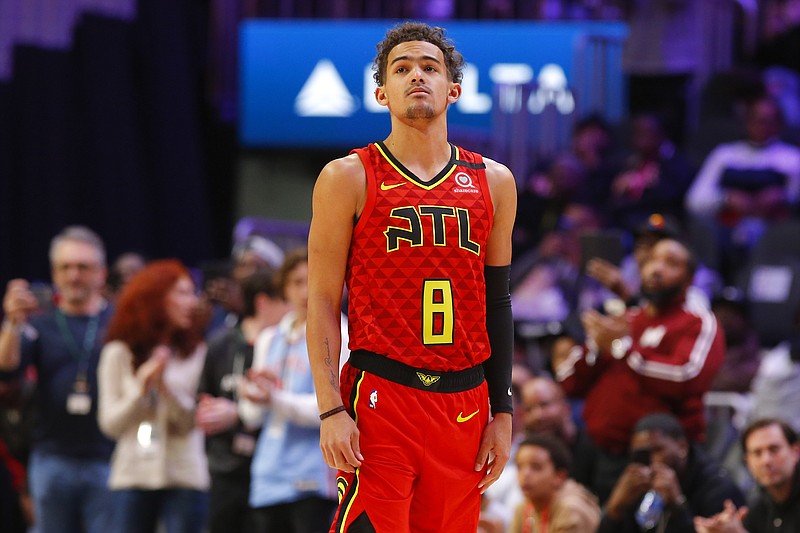 Atlanta Hawks point guard Trae Young wears a No. 8 jersey to honor former NBA player Kobe Bryant at the start of the team's home game against the Washington Wizards on Sunday night. Bryant and his daughter Gianna, nicknamed Gigi, died in a helicopter crash Sunday in California, and Young had developed a friendship with both of them. / AP photo by Todd Kirkland