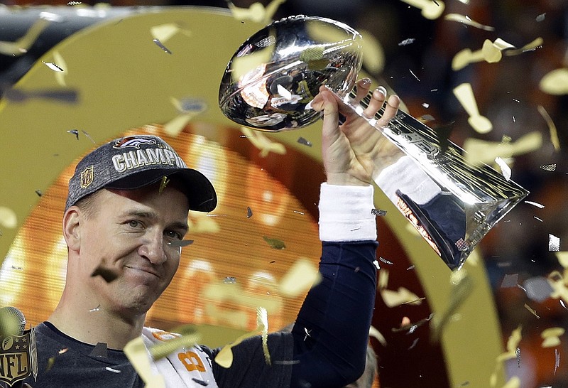 Denver Broncos quarterback Peyton Manning holds up the Vince Lombardi Trophy after his team beat the Carolina Panthers 24-10 at Super Bowl 50 on Feb. 7, 2016, in Santa Clara, Calif. Manning announced his retirement from professional football a month later. / AP photo by Julie Jacobson