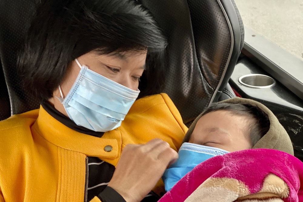 People wear masks on a bus in Quang Ninh province, Vietnam Tuesday, Jan. 28, 2018. China on Tuesday reported 25 more deaths from a new viral disease, as the U.S. government prepared to fly Americans out of the city at the center of the outbreak. (AP Photo/Hau Dinh)