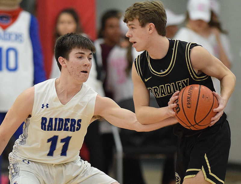 Cleveland's Grant Hurst (11) steals the ball from Bradley Central's Ashton Boyd in the host and state No. 1 Blue Raiders' win Monday night at Cleveland High School.
