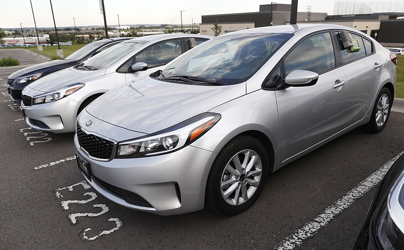 FILE - In this June 26, 2018, file photo a used 2017 Kia Forte sits in a row of other used, late-model sedans at a dealership in Centennial, Colo. Consumers bought an estimated 40.4 million used vehicles last year, likely passing the old record of 40.2 million set in 2018, according to figures from the Edmunds.com auto pricing site. (AP Photo/David Zalubowski, File)