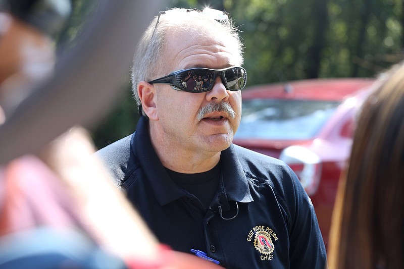 East Ridge Police Chief James Reed answers questions from reporters following the capture of a manhunt suspect at the entrance of Camp Jordan on Thursday, October 4, 2018 in East Ridge, Tennessee. Law enforcement employed the use of K-9 Units, a drone and officers on foot to find the suspect. / Staff photo by Erin O. Smith